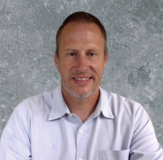 Image of Brian Overholser, PharmD, FCCP, smiling for the camera in front of a grey background.