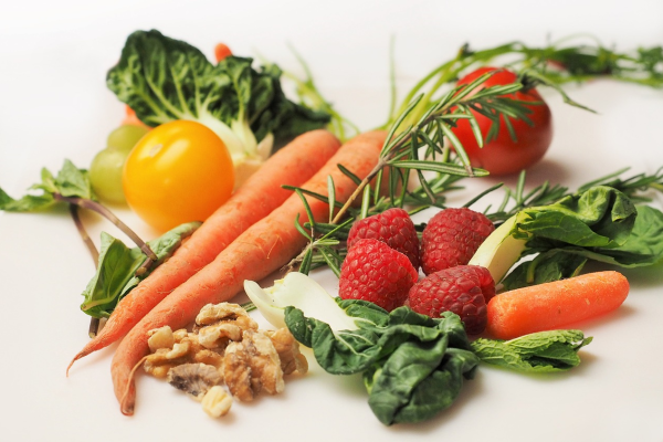 Image shows an assortment of fruits, nuts, and vegetables against a white background