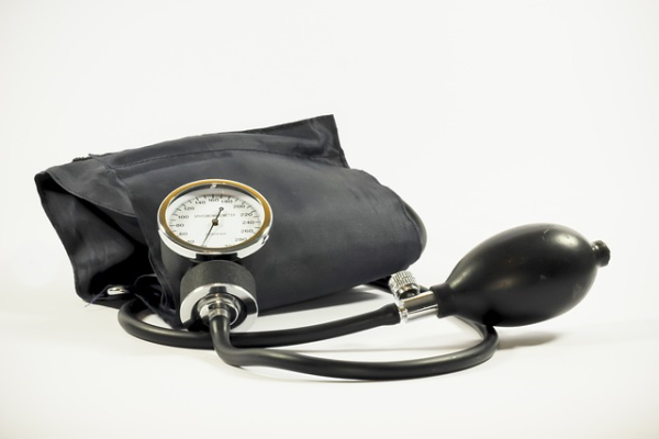 A black manual blood pressure cuff and inflater bulb sit on a white background.