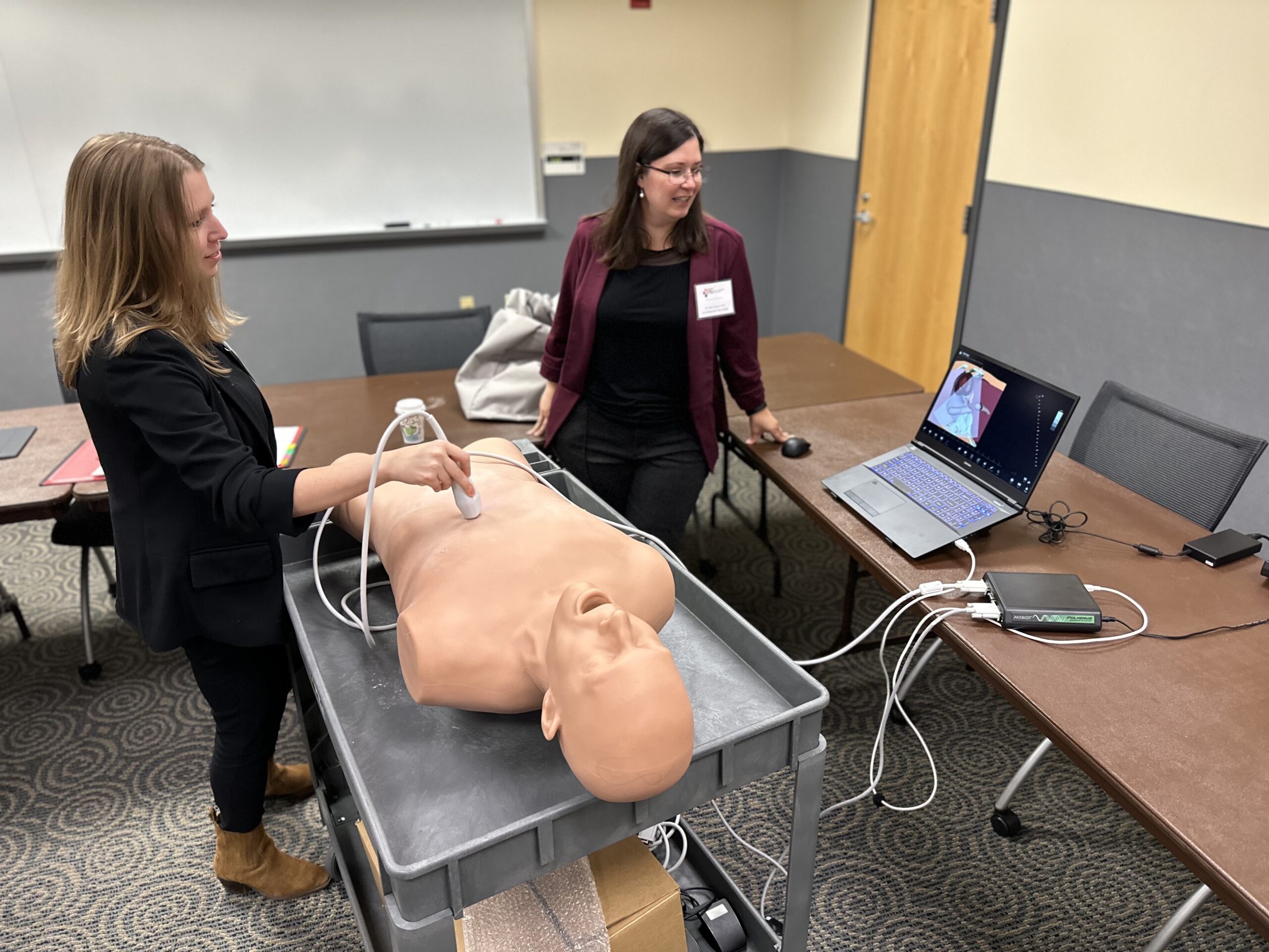 Kara Garcia, PhD, and Ellen Ireland, PhD, demonstrate PoCUS technology for attendees in Terre Haute.