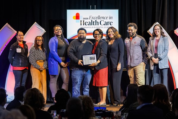 The iHEART team accepts an award at the 2025 IBJ awards.