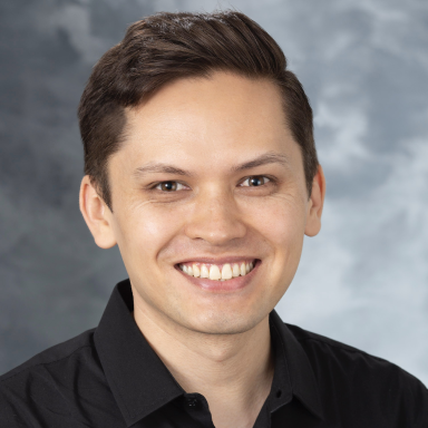 Robert Fujiki smiles in his headshot.