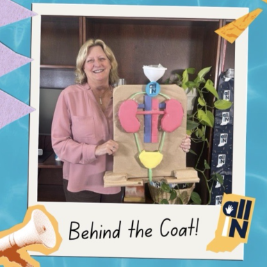 Dr. Sharon Moe poses with a simplified model of the kidney and bladder system. The image is made to look as though it is in a Polaroid film print, with a small megaphone graphic in the lower left, the All IN for Health logo in the lower right, and the words 'Behind the Coat' on the bottom of the Polaroid film.