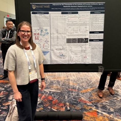 Caitlin Thomas in front of her poster.