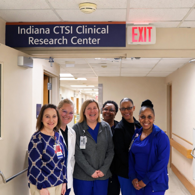 CRC staff pose together at the entrance to the CRC inpatient area.