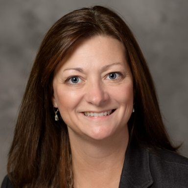 Karen Hinshaw smiles in her headshot.