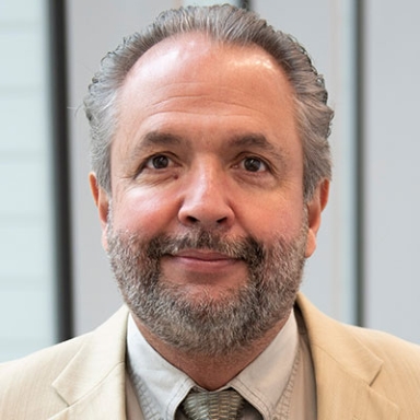 Gerardo Maupomé smiles in his headshot.