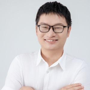 Xiaoping Bao smiles in his headshot.