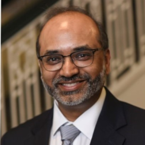 Samir Gupta smiles in his headshot.