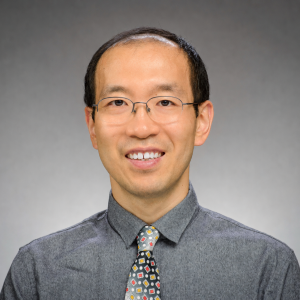 Xin Lu smiles in his headshot.
