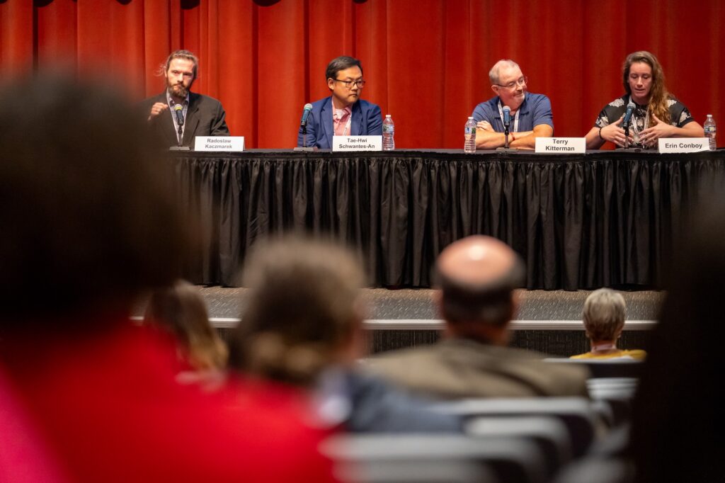 Four panelists face the audience.