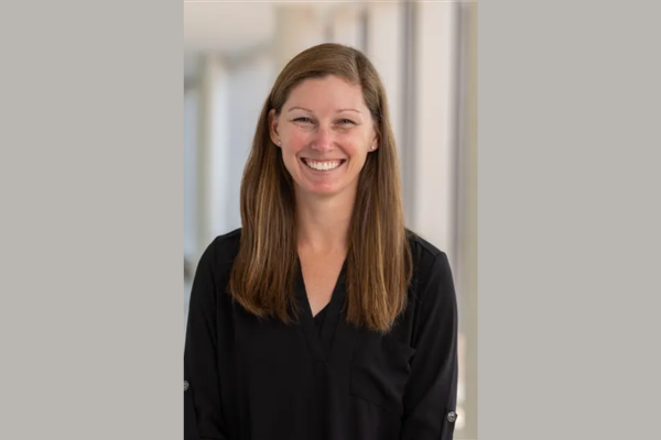 Lauren Magee smiles in her headshot, which is set against a light grey background.
