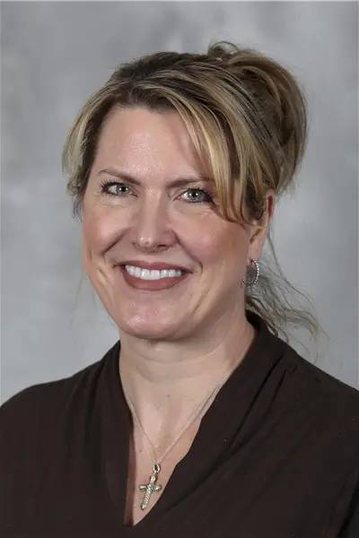 Stacey Halum smiles in her headshot.