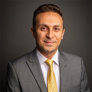 Edmond Ramly smiles in his headshot.