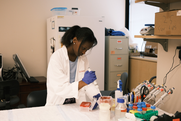 A student works in a lab as part of their summer internship.
