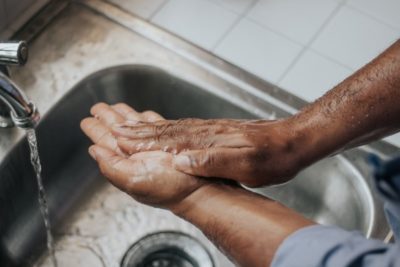 hands washing with soap in sink