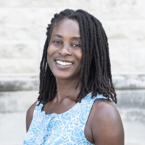 Nana Gletsu Miller smiles in her headshot.