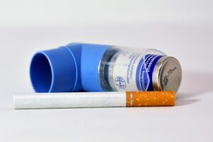 Image shows an inhaler and a cigarette 
