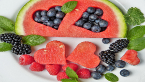 photo of watermelon with hearts cut out and filled with berries