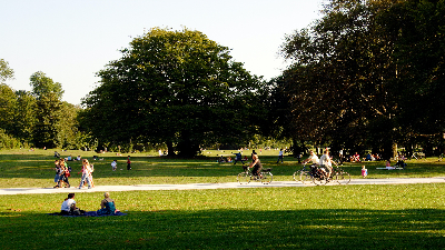 photo of park with people walking, biking and sitting