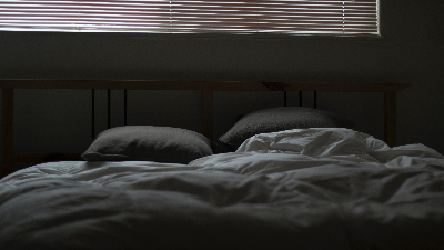 photo of a bed with blankets and pillows
