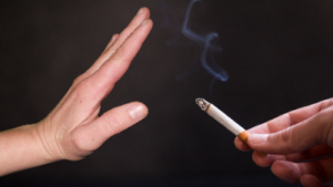 photo of hand refusing a cigarette that is being offered