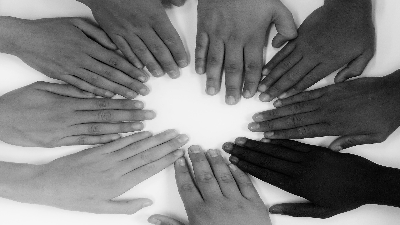 photo of hands of many races in a circle