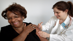 photo of a person receiving a vaccine by another person