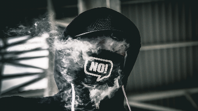 photo of a head covered with a hood and smoke with NO! on a mask