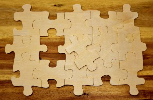 wooden puzzle pieces fit together with a single piece missing