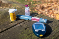 diabetic testing supplies laying on a picnic table